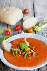 gazpacho with bread. cold soup made of tomatoes and watermelon - salmorejo . Spanish cuisine. soup with bread, butter, celery, cucumber. paleo diet. Orange color.