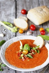 gazpacho with bread. cold soup made of tomatoes and watermelon - salmorejo . Spanish cuisine. soup with bread, butter, celery, cucumber. paleo diet. Orange color.