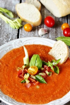 gazpacho with bread. cold soup made of tomatoes and watermelon - salmorejo . Spanish cuisine. soup with bread, butter, celery, cucumber. paleo diet. Orange color.