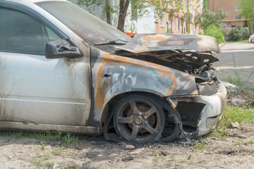 Burnt car on the street. Side view