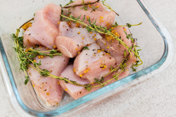 Raw turkey slices with thyme and mustard marinade ready to bake or grill