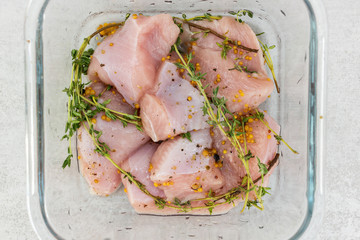 Raw turkey slices with thyme and mustard marinade ready to bake or grill