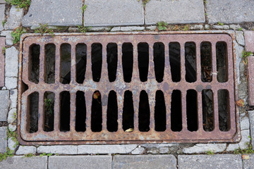 rusty old rectangular sewer grate