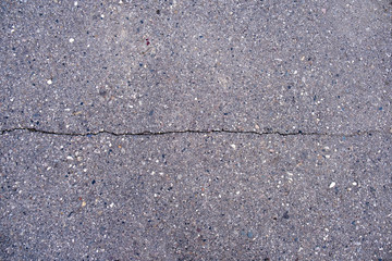 narrow long crack in asphalt