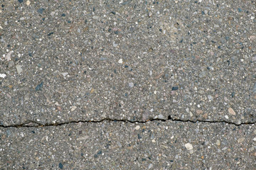 narrow long crack in asphalt