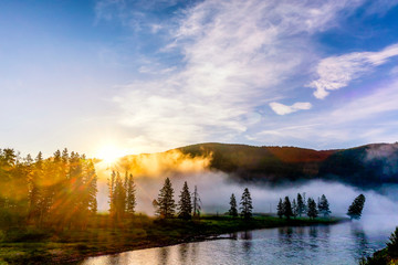 Sunbeams through Fog and Trees on River