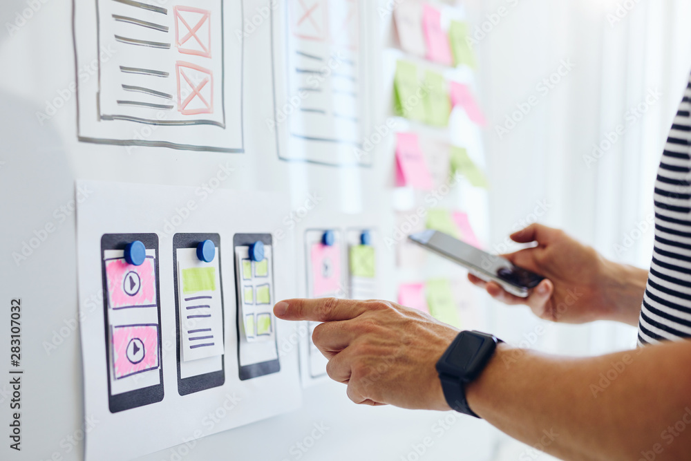 Wall mural close up of web developer planning application for mobile phone