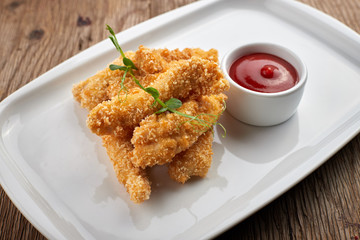 Cheese nuggets with sauce on a white plate