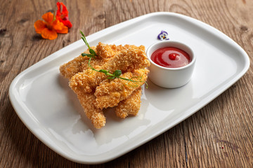 Cheese nuggets with sauce on a white plate