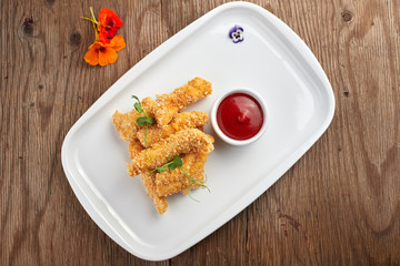 Cheese nuggets with sauce on a white plate