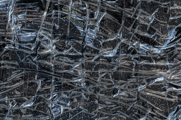 black polyethilene film enforced by sticky tape flat smuggle package closeup texture