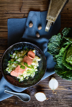Stamppot, traditional Dutch meal made from mashed potatoes and curly kale, served with sausage slices