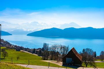 Fototapeta na wymiar Aerial panorama view of lake Lucerne and Weggis village in spring with Swiss alps in background.