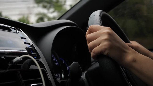 one person driving car in country road, hand control steering wheel