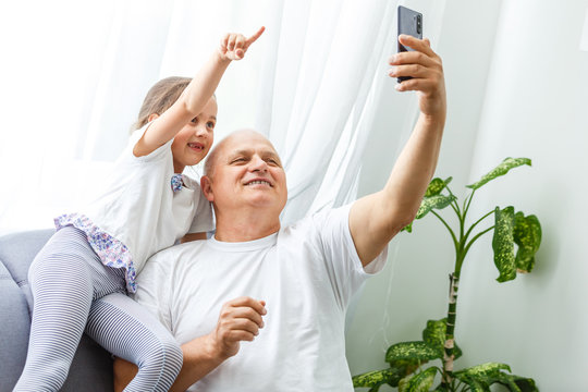 Grandfather and granddaughter make selfie