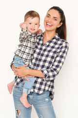 Pretty mom with handsome son weared in checked shirt on white background.