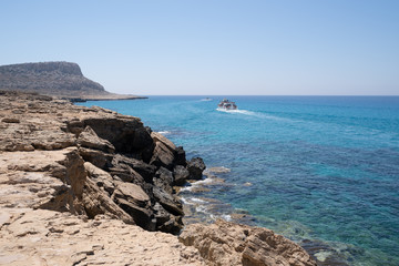 Cape Greco landscape with tourist ships passing by (Cavo Greco, Capo Greco).