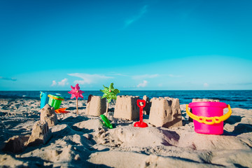 Sand castle on beach vacation and toys