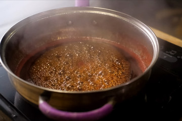 Boiling jam, jam to jam. boiling on fire in steel plate.