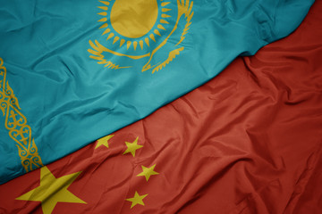 waving colorful flag of china and national flag of kazakhstan.