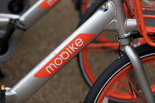 LONDON, ENGLAND - JANUARY 15, 2019: Mobike dockless bicycles parked in a street. Mobike is a bike sharing platform for short distance travel.