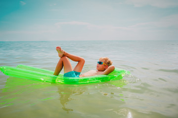 cute boy swimming at tropical beach, child relax at sea
