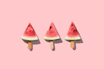 Flat lay top view of fresh watermelon slices on color background.