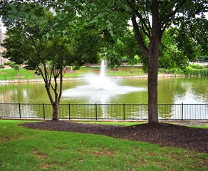 Lake and fountain with landscaping In city park 