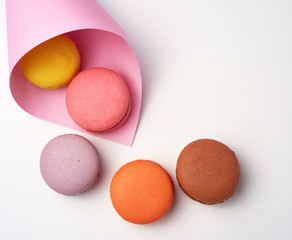 baked macarons in a pink paper bag