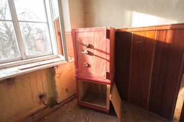 Fototapeta na wymiar Red steel safe in the abandoned room