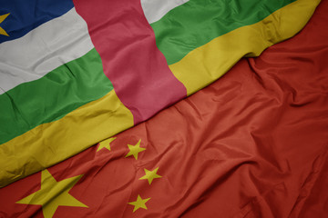 waving colorful flag of china and national flag of central african republic.