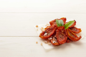 Sun dried tomatoes on wooden background