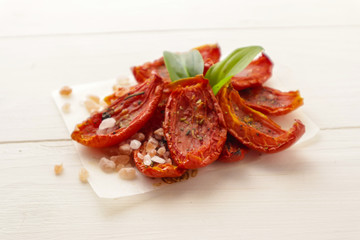 Sun dried tomatoes on wooden background