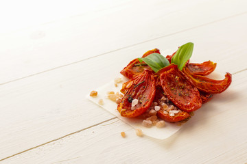 Sun dried tomatoes on wooden background