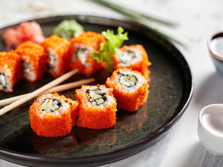 Closeup of japanese rolls on a dark plate