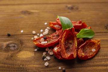 Sun dried tomatoes on wooden background