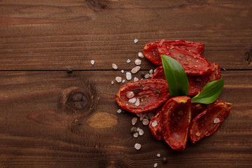 Sun dried tomatoes on wooden background