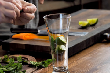 making cocktail of mint and lemon.