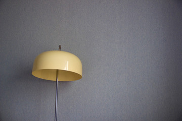 Retro oviform lamp on blue wall background