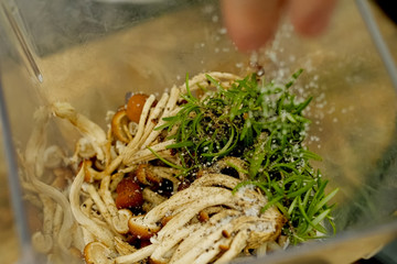 Mushrooms with seasoning and herbs in cup.