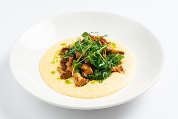 polenta with chanterelles on the white plate
