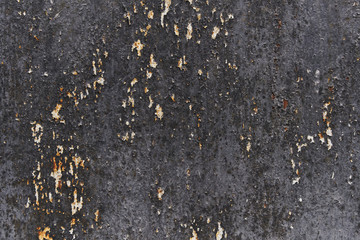 Peeling black paint on wall seamless texture. Pattern of rustic black grunge material.