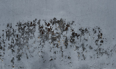 Peeling grey paint on wall seamless texture. Pattern of rustic grey grunge material.