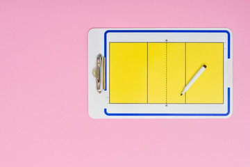Volleyball tactical board with marker on pink background. Top view