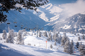Mayrhofen, Austria Zillertal Valley amid snowy fir trees and ski lift