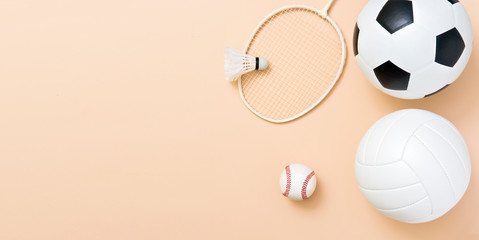 Assorted sports equipment including a basketball, soccer ball, volleyball, baseball, badminton...