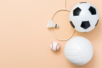 Assorted sports equipment including a basketball, soccer ball, volleyball, baseball, badminton...