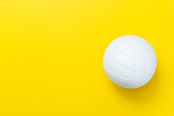 White volleyball leather ball on yellow background. Top view.