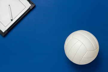 Volleyball and tactical board with marker on blue background. Top view