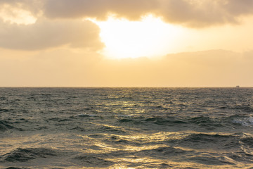 simple beautiful scenic landscape background photography of evening sunset cloudy weather above Caribbean sea wavy water surface to horizon 